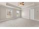 Bright bedroom with two windows, gray carpet, ceiling fan and crown molding at 2345 Gallard St, Lawrenceville, GA 30043