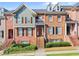 Attractive brick townhome featuring a well-maintained landscape and a charming exterior staircase at 2345 Gallard St, Lawrenceville, GA 30043