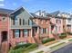 Brick townhomes featuring steps to entryways and small manicured bushes and trees at 2345 Gallard St, Lawrenceville, GA 30043