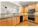 Kitchen featuring wood cabinets, granite countertops, and stainless steel appliances at 2345 Gallard St, Lawrenceville, GA 30043