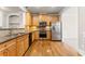 Kitchen with wooden cabinets, stainless appliances and fixtures, and hardwood flooring at 2345 Gallard St, Lawrenceville, GA 30043