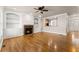 Open living area with fireplace, built-in shelving, and hardwood flooring at 2345 Gallard St, Lawrenceville, GA 30043