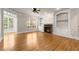 Open living room featuring hardwood floors, a fireplace, and built-in shelving at 2345 Gallard St, Lawrenceville, GA 30043