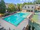 Aerial view of a community pool and tennis court surrounded by lush greenery and residential buildings at 2345 Gallard St, Lawrenceville, GA 30043