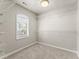 Spacious carpeted walk-in closet with white wire shelving and a window allowing natural light at 2345 Gallard St, Lawrenceville, GA 30043