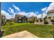 Landscaped backyard offering a grassy lawn, patio, and clear blue skies at 2486 Bear Mountain St, Lithonia, GA 30058