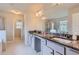 Luxurious bathroom with double granite vanity, tile flooring, and glass shower at 2486 Bear Mountain St, Lithonia, GA 30058