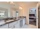 Bathroom with dual granite vanity, tile flooring, and access to a bedroom at 2486 Bear Mountain St, Lithonia, GA 30058