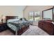 Cozy bedroom featuring a comfortable bed, dresser, and view from the window at 2486 Bear Mountain St, Lithonia, GA 30058
