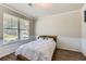 Well-lit bedroom with panel molding and a view through the window at 2486 Bear Mountain St, Lithonia, GA 30058