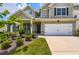 Beautiful two-story home with an attached two-car garage, tidy landscaping, and a welcoming front porch at 2486 Bear Mountain St, Lithonia, GA 30058
