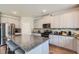 Well-equipped kitchen with gray cabinets, granite countertops, stainless steel appliances, and a large island at 2486 Bear Mountain St, Lithonia, GA 30058