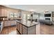 Open-concept kitchen with a granite-topped island and modern appliances, flowing into the dining and living areas at 2486 Bear Mountain St, Lithonia, GA 30058