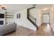 Bright living room featuring hardwood floors, a staircase, a fireplace, and a large picture window at 2486 Bear Mountain St, Lithonia, GA 30058