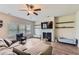 Comfortable living room with a fireplace, TV, ceiling fan, and hardwood floors at 2486 Bear Mountain St, Lithonia, GA 30058