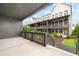 Back porch view of townhomes with landscaped lawns, mulch beds, and manicured shrubs at 6710 Pippin Walk, Alpharetta, GA 30005