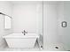 Modern bathroom features a soaking tub and glass-enclosed shower at 6710 Pippin Walk, Alpharetta, GA 30005