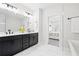 Spa-like bathroom with double vanity, large mirror, and a door leading to the bedroom at 6710 Pippin Walk, Alpharetta, GA 30005