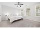 Bright bedroom with neutral carpet, ceiling fan, and two large windows at 6710 Pippin Walk, Alpharetta, GA 30005