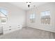 Neutral bedroom featuring carpet flooring and multiple windows providing ample natural light at 6710 Pippin Walk, Alpharetta, GA 30005