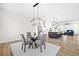 Bright open concept dining area features modern light fixture and flows into the spacious kitchen at 6710 Pippin Walk, Alpharetta, GA 30005