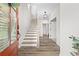 Bright foyer with wood floors, stairs leading up, and an open doorway at 6710 Pippin Walk, Alpharetta, GA 30005
