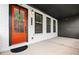 Front entrance featuring a bright orange door with a wreath and white brick at 6710 Pippin Walk, Alpharetta, GA 30005