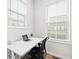 Bright home office space features a white desk and dual windows at 6710 Pippin Walk, Alpharetta, GA 30005