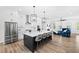 Open-concept kitchen with stainless steel appliances, a large island, and stylish pendant lighting at 6710 Pippin Walk, Alpharetta, GA 30005