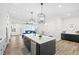 Open concept Kitchen with an island, stainless steel appliances and view into the living room at 6710 Pippin Walk, Alpharetta, GA 30005