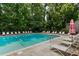 Community pool surrounded by lounge chairs and mature trees at 149 Rondak Se Cir, Smyrna, GA 30080