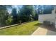 A section of fenced backyard with vibrant green grass and shade from mature trees at 1615 Gunnin Nw Trce, Atlanta, GA 30318