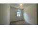 A neutral-toned bedroom features a large window providing ample natural light at 1615 Gunnin Nw Trce, Atlanta, GA 30318