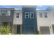 Townhome exterior with blue and white siding, a one-car garage, and a front door at 1615 Gunnin Nw Trce, Atlanta, GA 30318