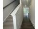 Bright hallway with wood floors, stairs, and view into living area at 1615 Gunnin Nw Trce, Atlanta, GA 30318