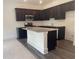Kitchen featuring dark cabinetry, granite countertops, stainless appliances, and tile backsplash at 1615 Gunnin Nw Trce, Atlanta, GA 30318