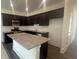 An open kitchen with granite countertops and dark cabinets at 1615 Gunnin Nw Trce, Atlanta, GA 30318