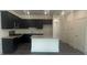 Stylish kitchen with dark cabinets, granite countertops, and a central island at 1615 Gunnin Nw Trce, Atlanta, GA 30318