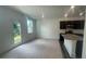 Bright, open-concept living space featuring modern kitchen with stainless steel appliances and a walkout to the yard at 1615 Gunnin Nw Trce, Atlanta, GA 30318
