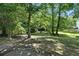 Expansive backyard with mature trees providing plenty of shade, with bricked patio at 5487 Walnut Lane Ln, Stonecrest, GA 30038