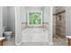 Spa-like bathroom featuring a soaking tub, separate shower, and natural light at 5487 Walnut Lane Ln, Stonecrest, GA 30038