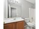 Bathroom with single sink vanity, full mirror, toilet, and tub with shower at 5487 Walnut Lane Ln, Stonecrest, GA 30038