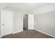 Neutral bedroom featuring plush carpeting, with white trim and walls, with two doors at 5487 Walnut Lane Ln, Stonecrest, GA 30038