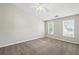 Bright bedroom with neutral walls, plush carpeting, and a ceiling fan for comfort at 5487 Walnut Lane Ln, Stonecrest, GA 30038