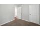 Image showing empty bedroom with two doors, neutral carpet, and neutral walls at 5487 Walnut Lane Ln, Stonecrest, GA 30038