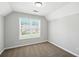 Bright bedroom with large window providing ample natural light and neutral carpeting at 5487 Walnut Lane Ln, Stonecrest, GA 30038