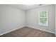 View of a bedroom with neutral walls, carpet flooring, and a window at 5487 Walnut Lane Ln, Stonecrest, GA 30038
