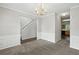 Formal dining room featuring chair rail molding, carpet, and a decorative chandelier at 5487 Walnut Lane Ln, Stonecrest, GA 30038