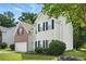 Charming two-story home with brick and siding exterior, an attached garage, and manicured landscaping at 5487 Walnut Lane Ln, Stonecrest, GA 30038