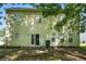 Back exterior of home with siding, sliding glass door, and mature trees at 5487 Walnut Lane Ln, Stonecrest, GA 30038
